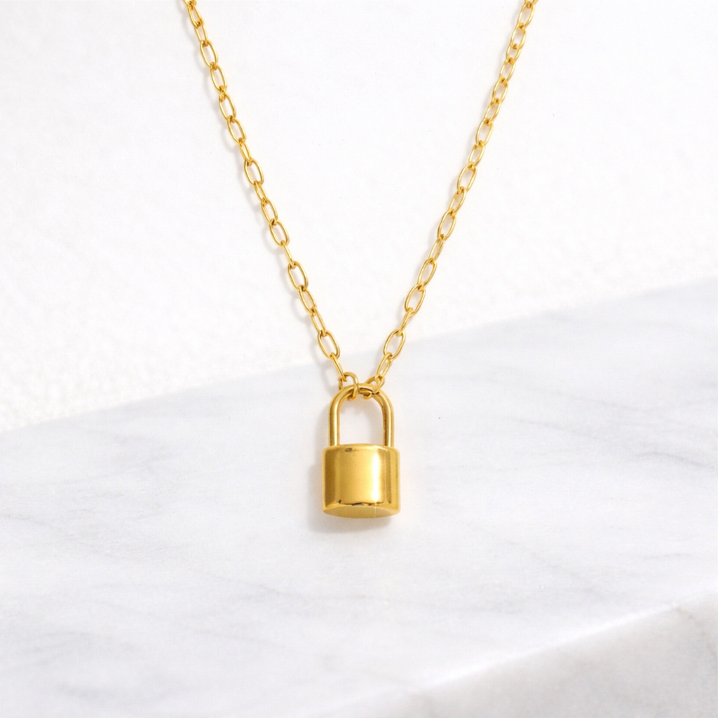 Gold Lock Pendant on a paperclip chain necklace on a white background