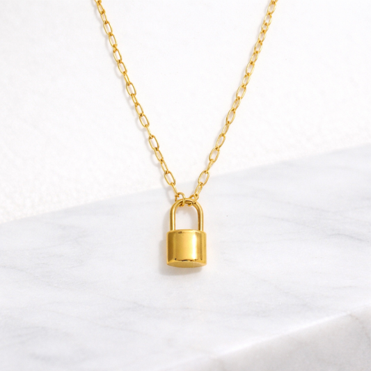 Gold Lock Pendant on a paperclip chain necklace on a white background