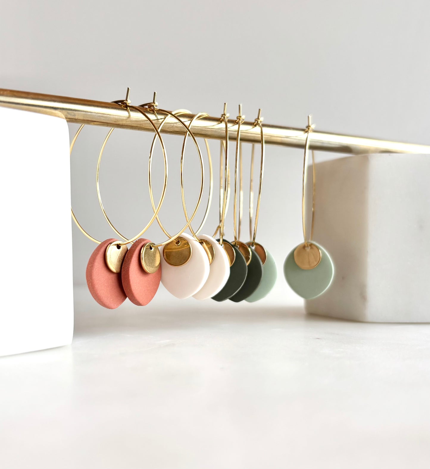 ODILLIA - Drop-style hoop earring.