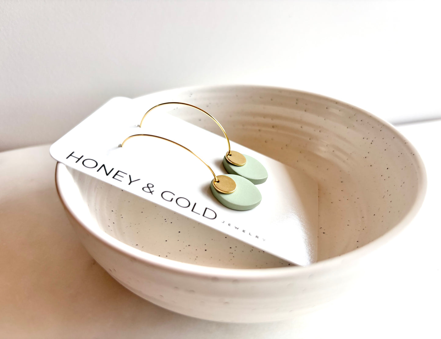 ODILLIA - Drop-style hoop earring.