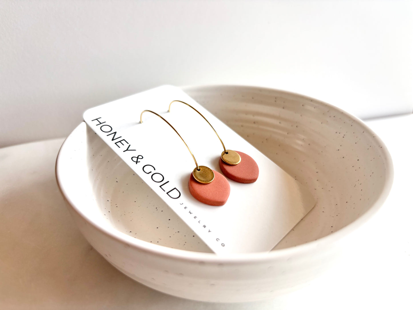 ODILLIA - Drop-style hoop earring.