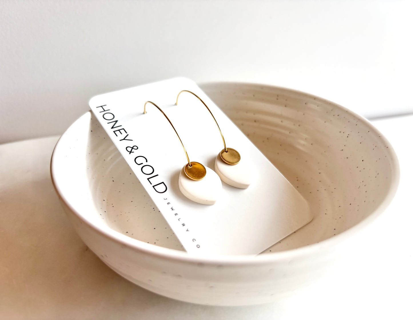 ODILLIA - Drop-style hoop earring.