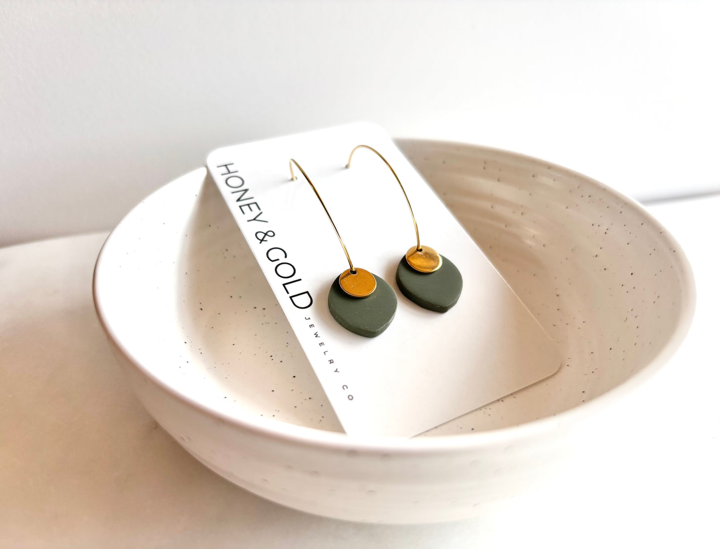 ODILLIA - Drop-style hoop earring.