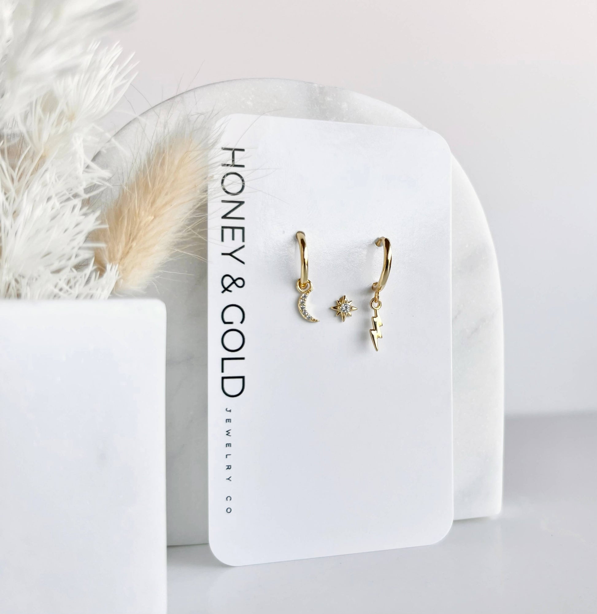 Celestial Trio Huggie Earring Set featuring moon, star, and lightning bolt charms in 925 gold-plated sterling silver