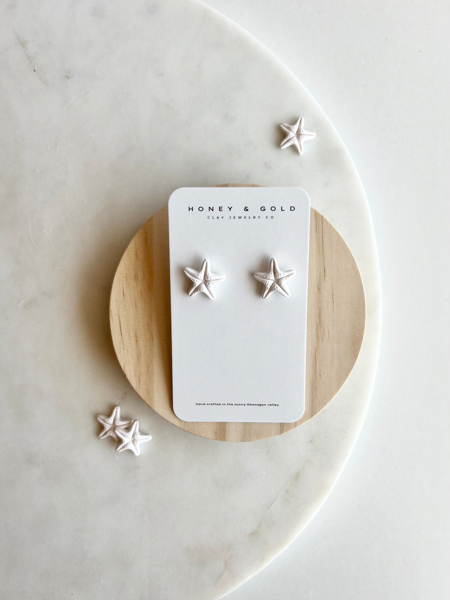 "White starfish stud earrings: a beachy vibe meets modern elegance."