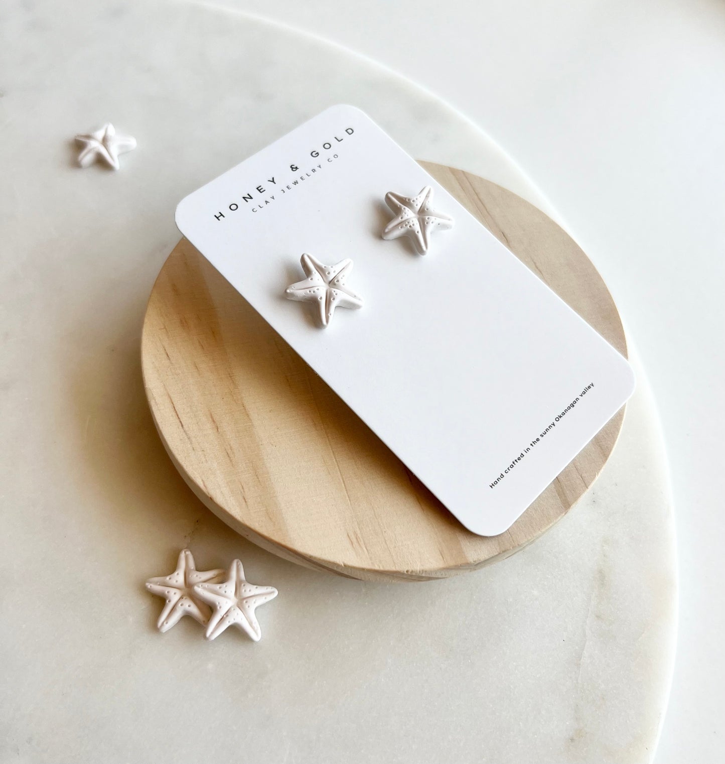 "White starfish stud earrings: a beachy vibe meets modern elegance."